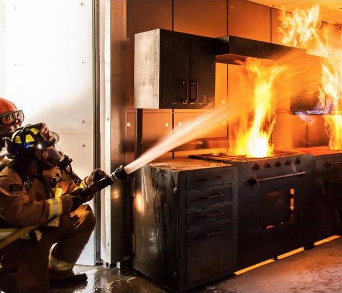 Fire fighters extinguishing a kitchen fire.