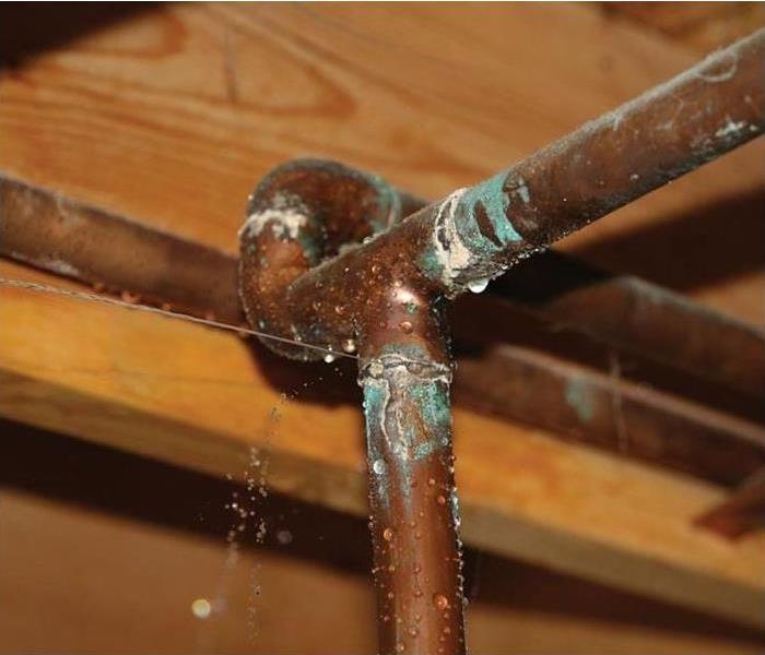 Copper pipe experiencing a small leak.