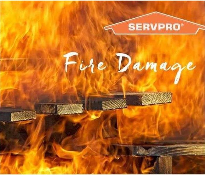 Fire Damage with fire burning wood and SERVPRO logo.